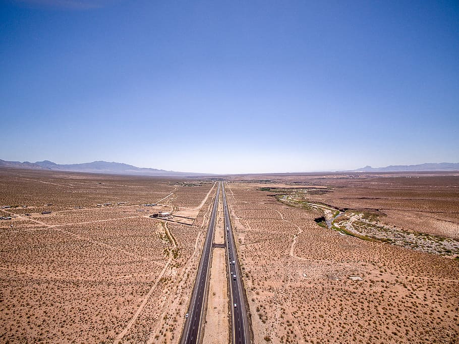 aerial photography of road, two gray road in the middle of the dessert HD wallpaper