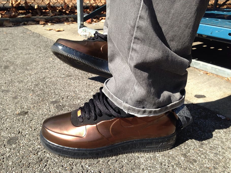 man wearing pair of brown Nike shoes on concrete floor, Jordan