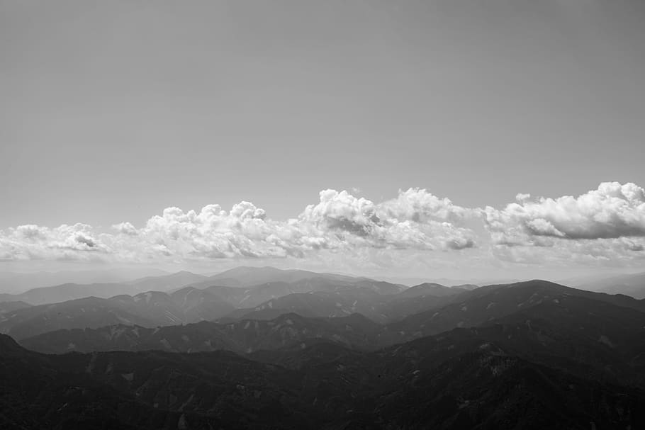 cloud formation under mountains, grayscale photography of mountain HD wallpaper