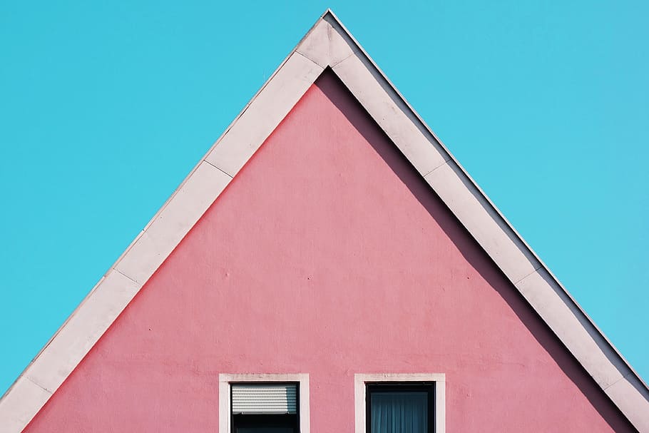 pink and white painted house, closeup photo of pink house, blue