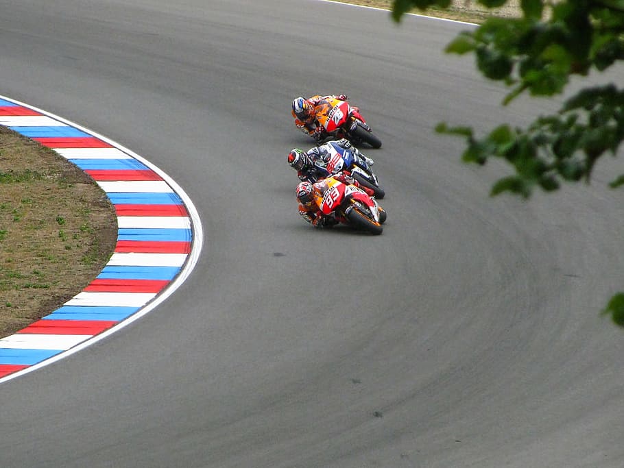 three person riding on sports bike on race track, marc marquez
