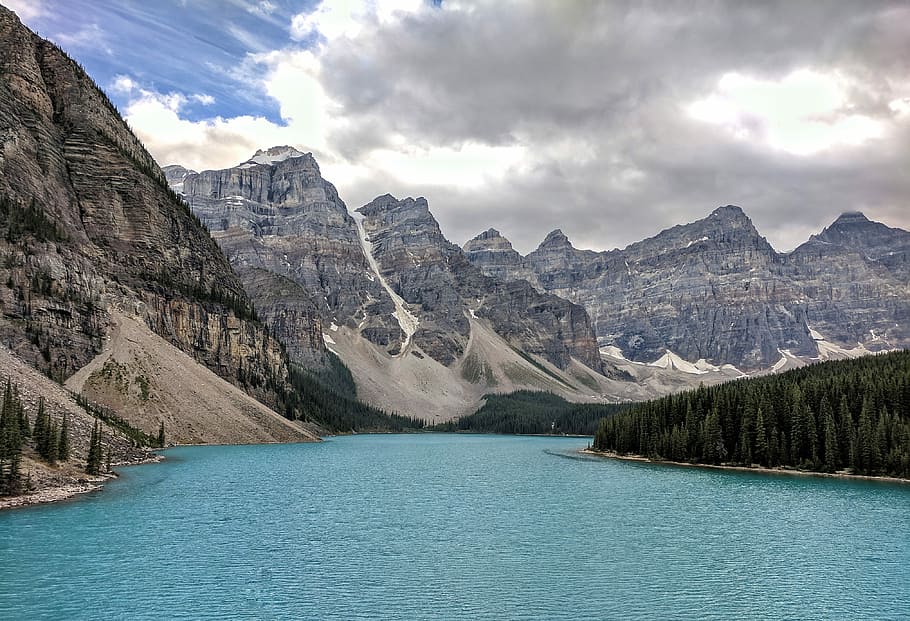 river beside brown mountains under blue and white cloudy sky HD wallpaper