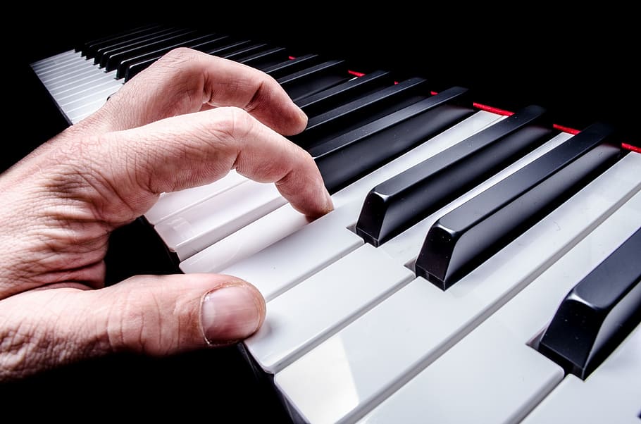 person's hand on black piano, pianist, music, instrument, playing