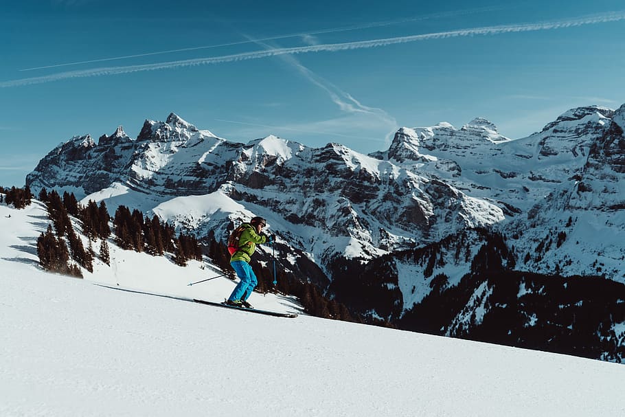 person snow skiing near snow capped mountain, person doing snow skis HD wallpaper