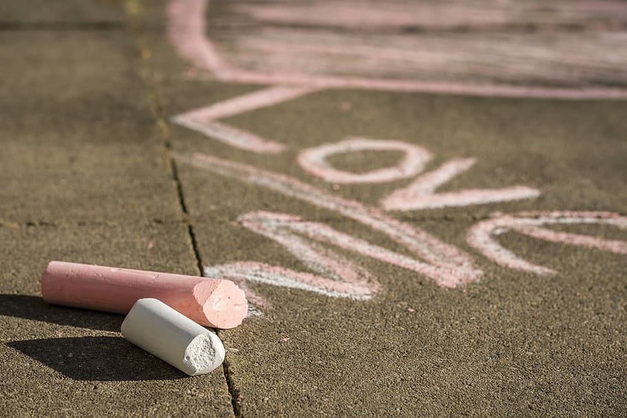 two pink and white chalks on asphalt road with love graffiti during daytime, HD wallpaper