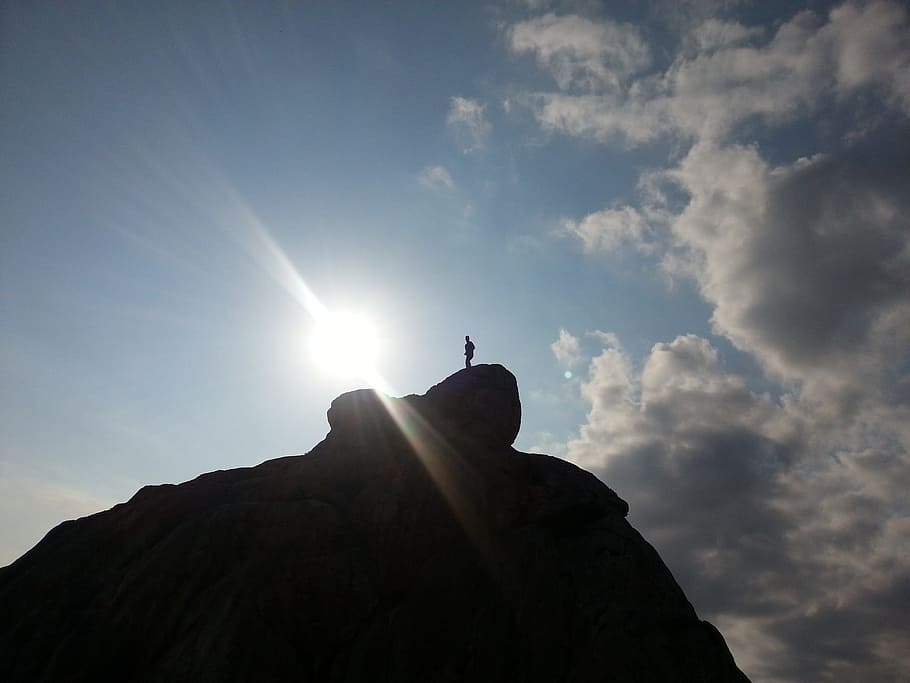silhouette photography of person on top of hill at daytime HD wallpaper