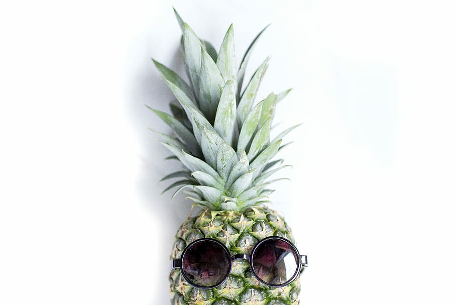 focus photo of green pineapple, pineapple with black sunglasses on white surface HD wallpaper