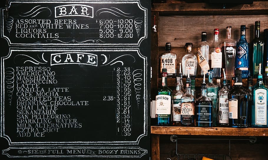 assorted alcoholic bottles on brown wooden rack beside black chalkboard HD wallpaper