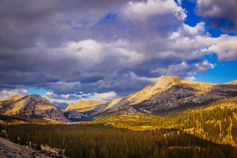 mountains and trees under blue and white sky at daytime photography, landscape photo of mountains under cloudy sky during daytime HD wallpaper