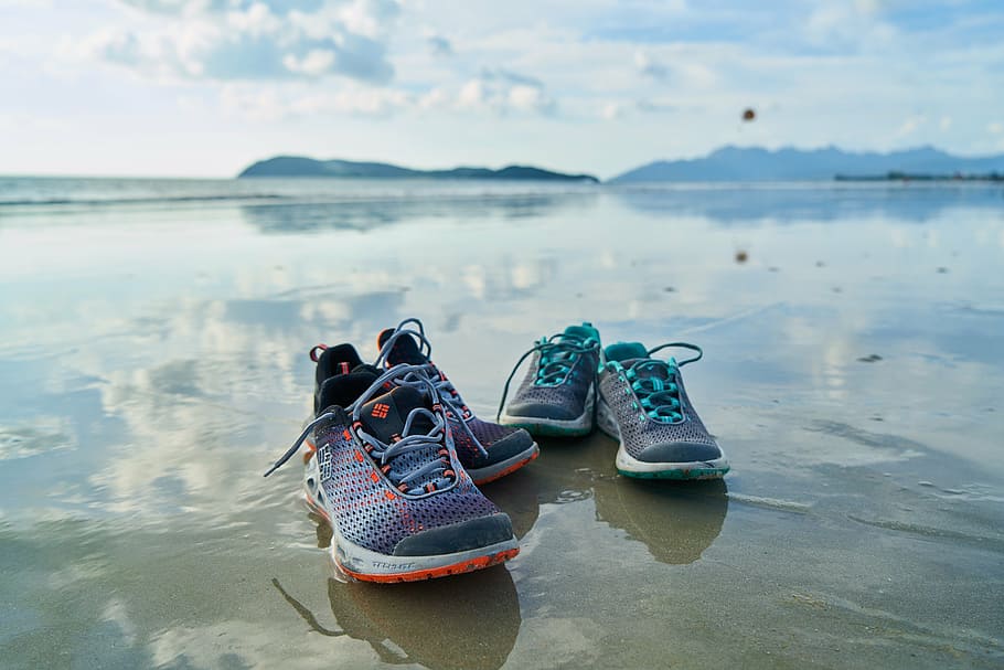two pairs of athletic shoes on grey sand beach shore, sports, HD wallpaper