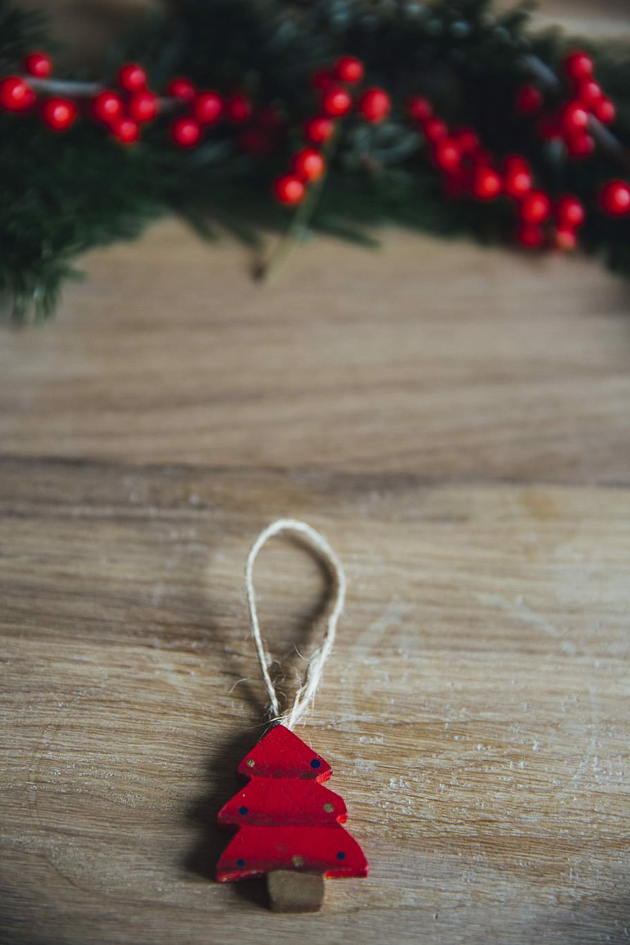 red pine tree hanging decor on brown wood plank, shallow focus photography of red tree ornament HD wallpaper