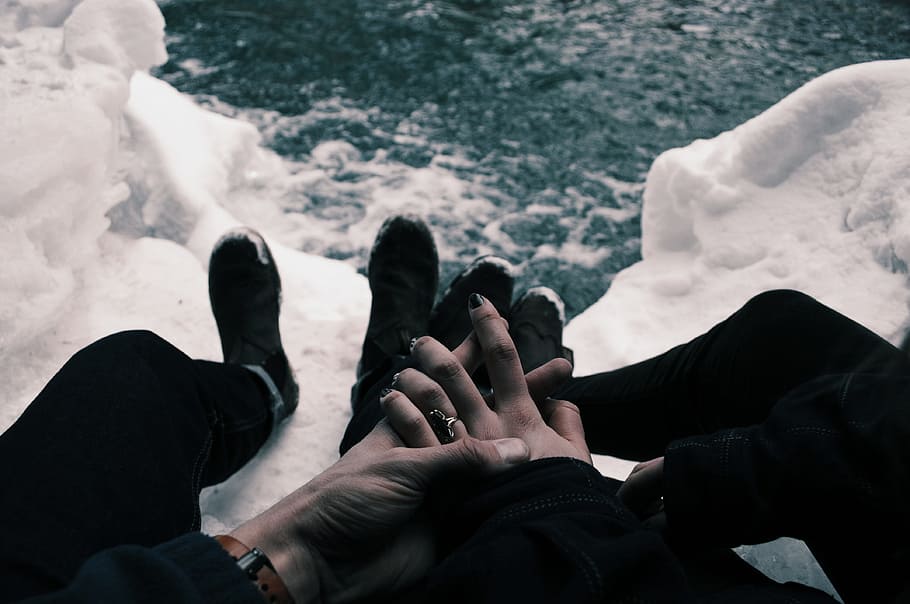 couple holding hands near body of water during daytime, minimalist photography of man and woman holding hands together below a river HD wallpaper