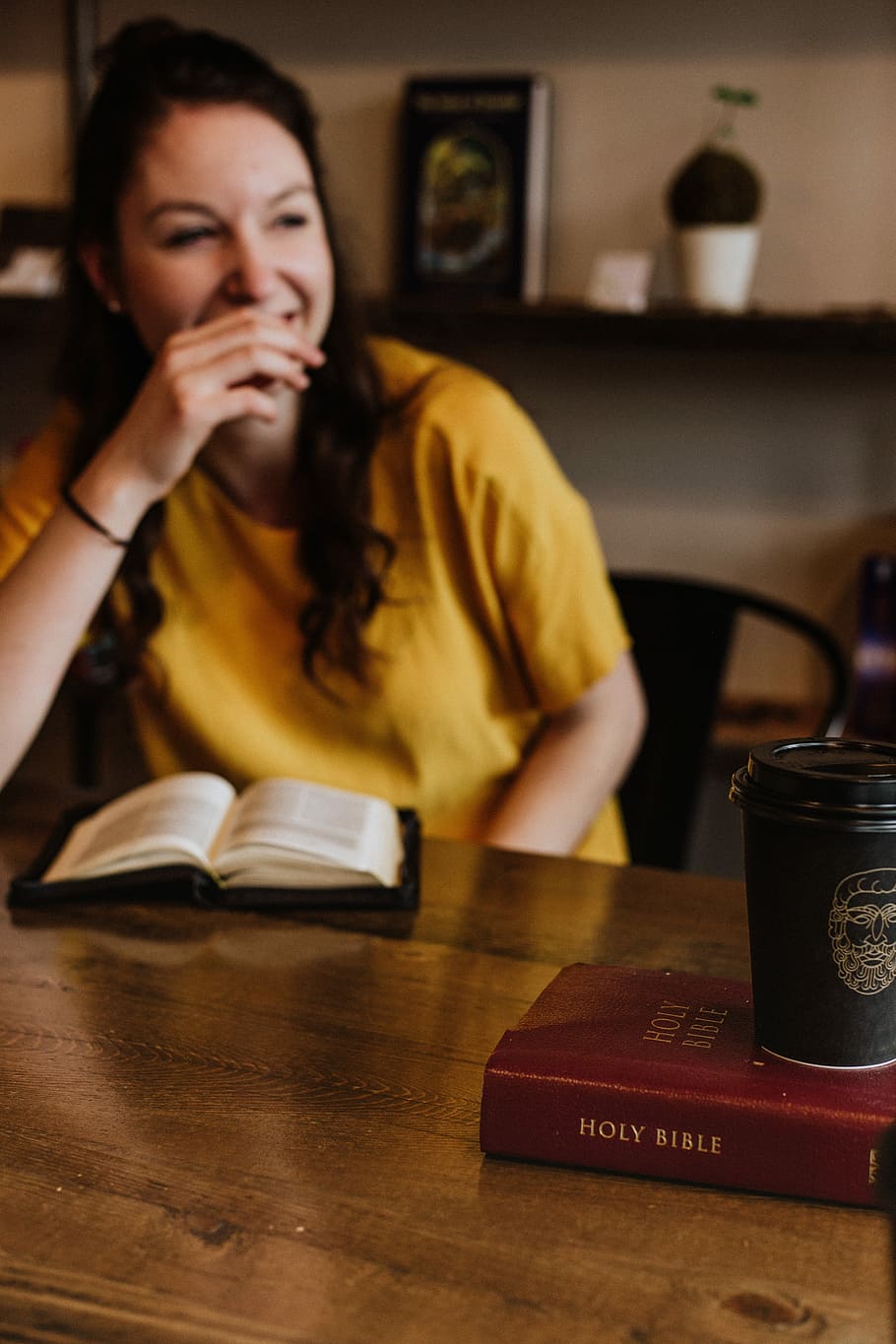 woman siting on chair near on holy bible, woman sitting in front of the book on desk HD wallpaper
