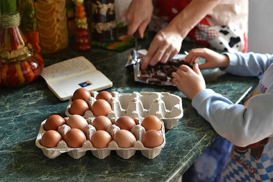 pile of organic eggs on tray on green tile table, food, hand HD wallpaper