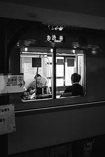 grayscale photo of two people sitting in train, grayscale photography of man and woman sitting inside train HD wallpaper