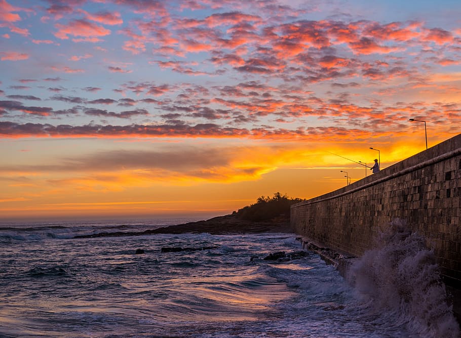 Carcavelos evening., ocean waves slamming on concrete dock during golden hour HD wallpaper