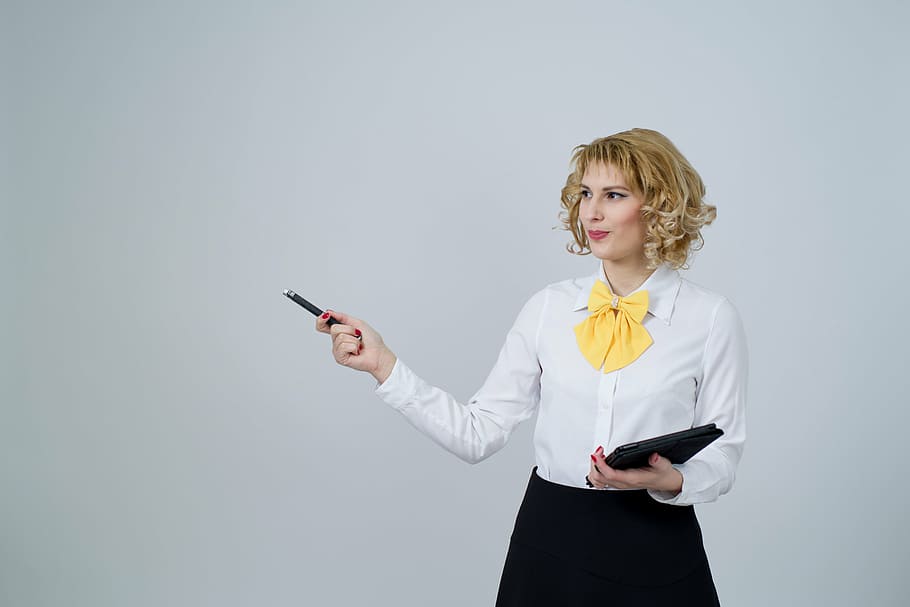 woman in white long-sleeved blouse holding laser pen, business woman