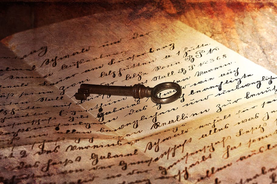 black skeleton key on printing paper, letters, handwriting, old