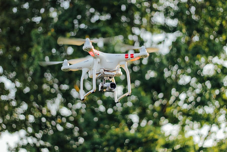DJI Phantom drone flying midair, selective focus photography of DJI Phantom 3 Standard drone on air HD wallpaper