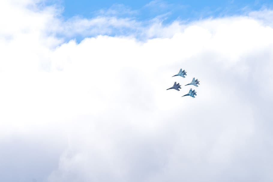 four blue fighting planes surrounded white clouds, bird's-eye view photography of four gray fighter planes HD wallpaper