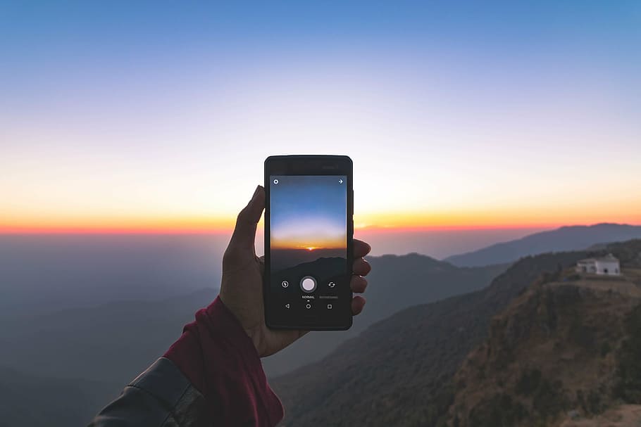 man taking photo of sun rise using smartphone, cellphone, mobile HD wallpaper