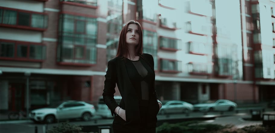 woman wearing black long-sleeved dress standing near building at daytime, HD wallpaper