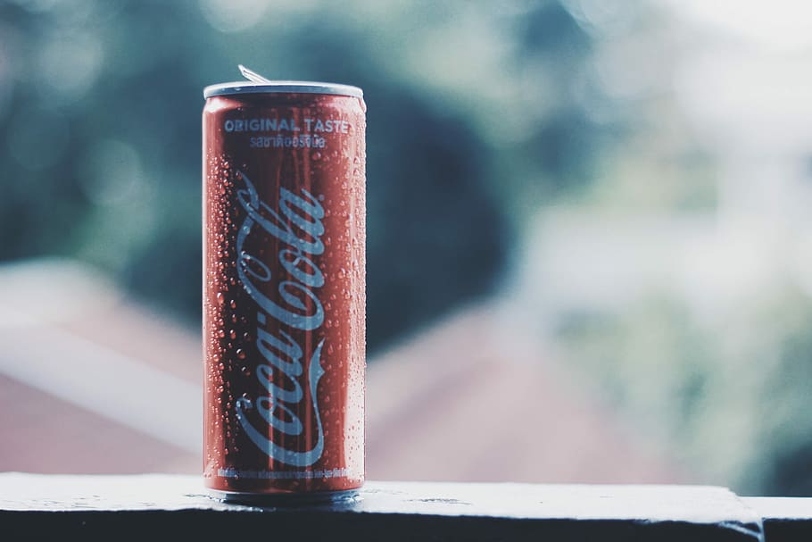 bokeh photography of Coca-Cola soda can during daytime, selective focus photography of Coca-Cola can on black surface at daytime, HD wallpaper