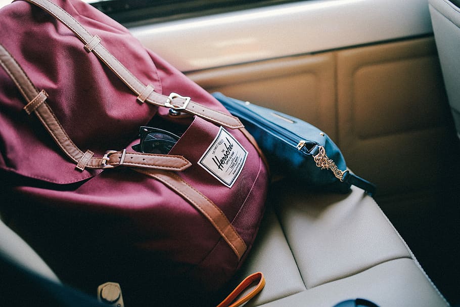maroon Herschel bag inside car, red knapsack bag, backpack, brand HD wallpaper