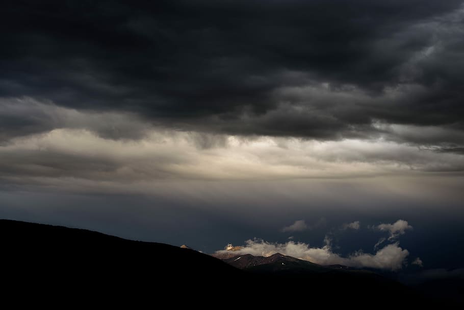 white clouds under blue sky, silhouette photography of mountain under nimbus clouds HD wallpaper