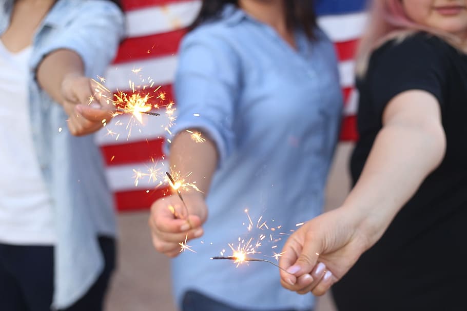 three person holds lighted sparkler firecrackers, sparklers HD wallpaper
