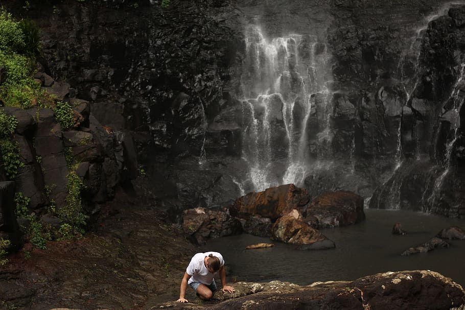 person climbing on rock near water fall, person climbing on rock near body of water HD wallpaper