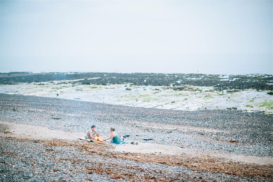man and woman sitting on beach, three, person, sand, daytime HD wallpaper