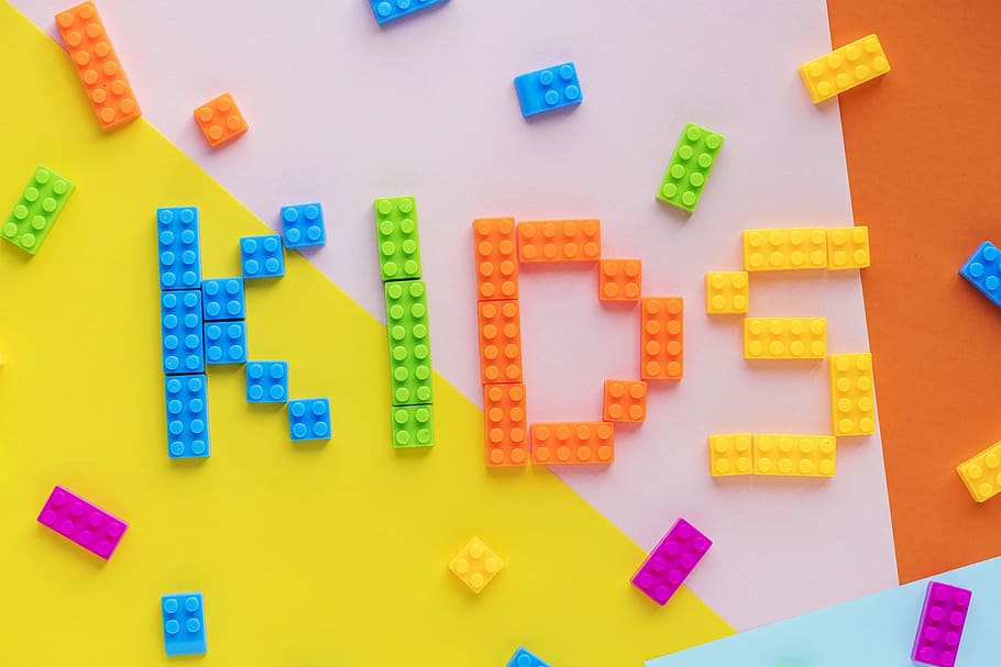 flat-lay photography of kids-spelled interlocking toy block, alphabet
