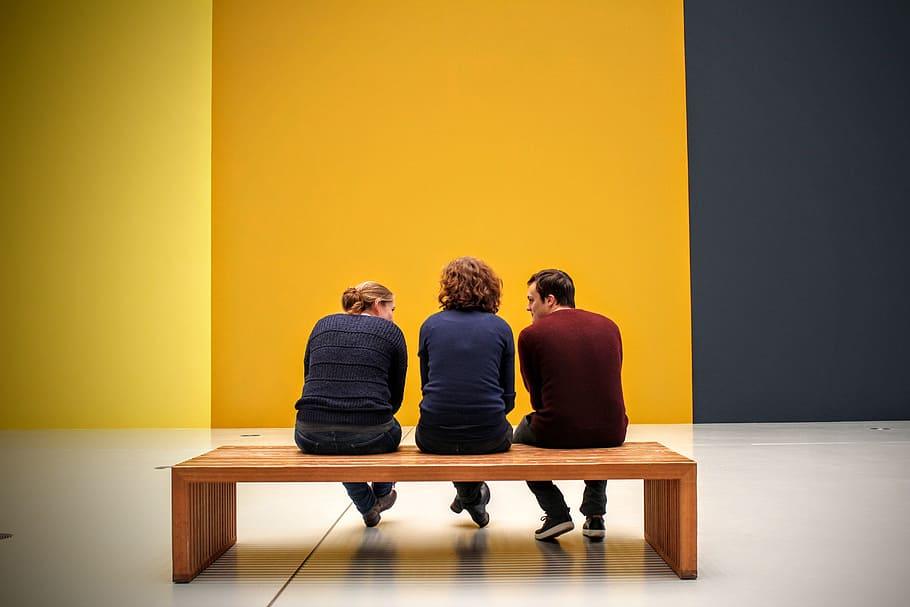 three people sitting on wooden bench, Exhibition, Visitors, Gallery