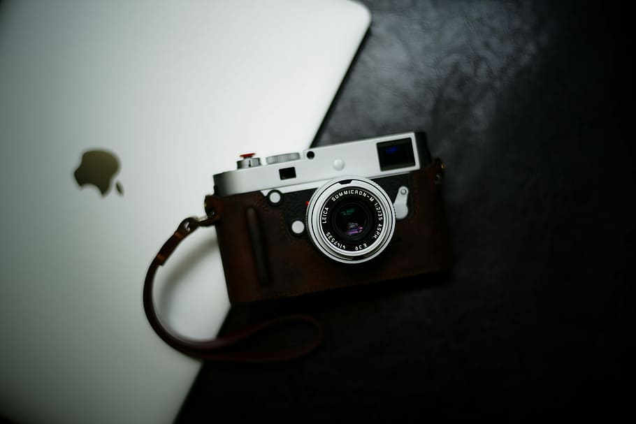 flat lay photography of camera near MacBook, flat lay photography of black and gray bridge camera on silver MacBook HD wallpaper