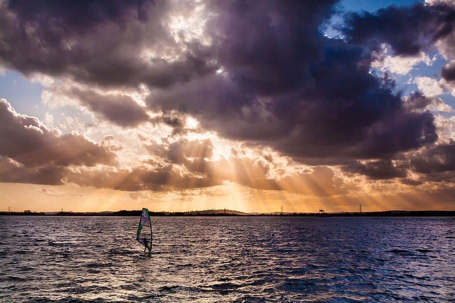 person windsurfing during golden hour, sunbeams, sky, clouds HD wallpaper