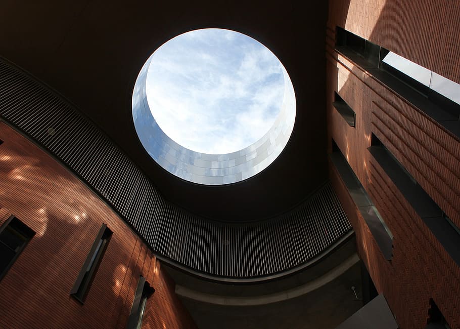 low angle photo of building interior, interior of brown and black building with hole in ceiling low-angle photography HD wallpaper