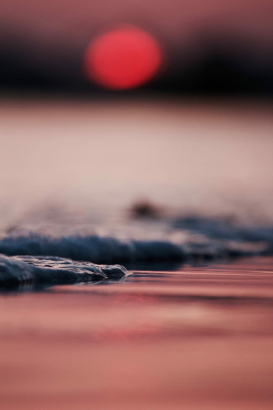 selective focus photography of cliff beside body of water during golden hour, low angel photo of body of water HD wallpaper