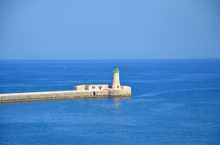 white concrete lighthouse surrounded by ocean at daytime, malta HD wallpaper