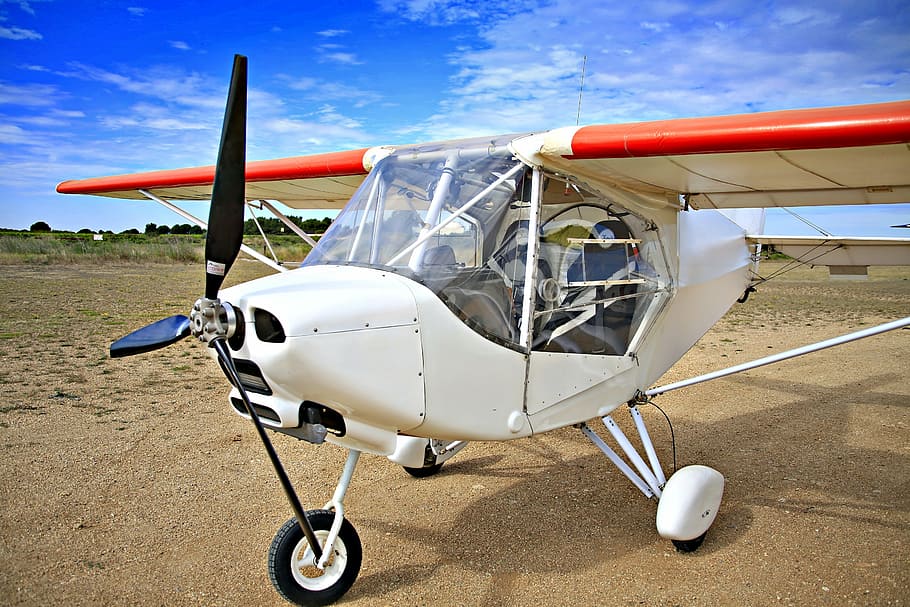 white and orange plane on brown ground, aircraft, sky, clouds HD wallpaper
