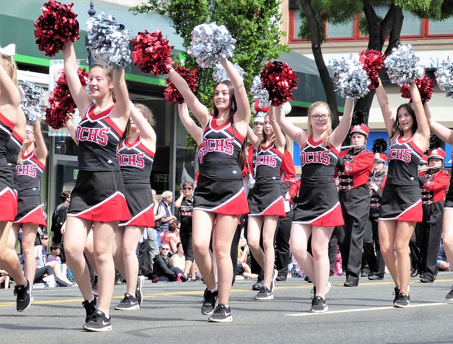 cheerleader women dancing on road during daytime, parade, cheerleaders