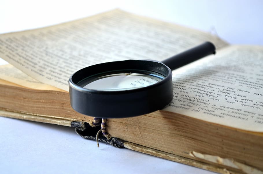 black magnifying glass on book, magnifier, loupe, dictionary