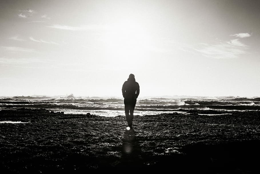 Grayscale photo of man standing near window photo – Free Cloud