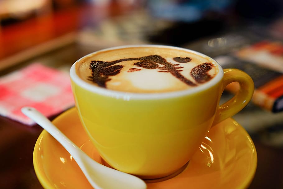 yellow ceramic teacup with cat designed coffee, coffee latte art HD wallpaper