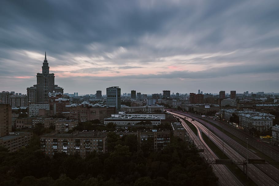 aerial photo of white concrete buildings, aerial photo of building under cloudy sky HD wallpaper