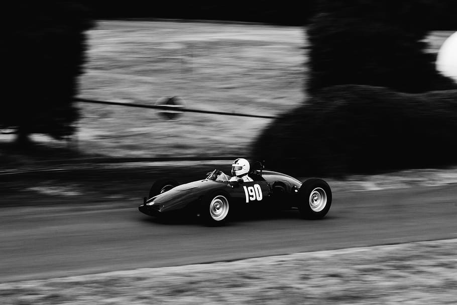 panning photography of racer, grayscale photo of a person riding a race car HD wallpaper