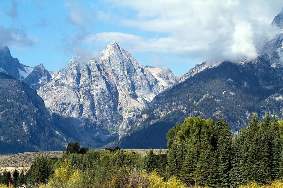mountains under white clouds during daytime, grand teton national park