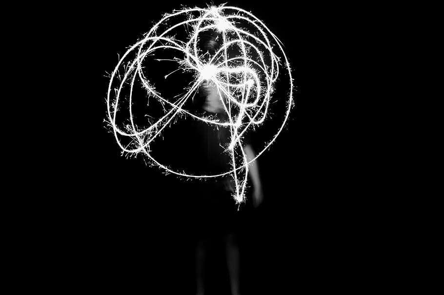 grayscale photography of person playing with light, time lapse photo of person holding sparkle HD wallpaper