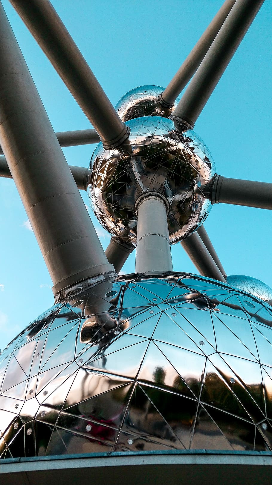 silver-colored spherical structure with attached gray pipes under blue sky, worms eye view photography of atomium landmark, HD wallpaper