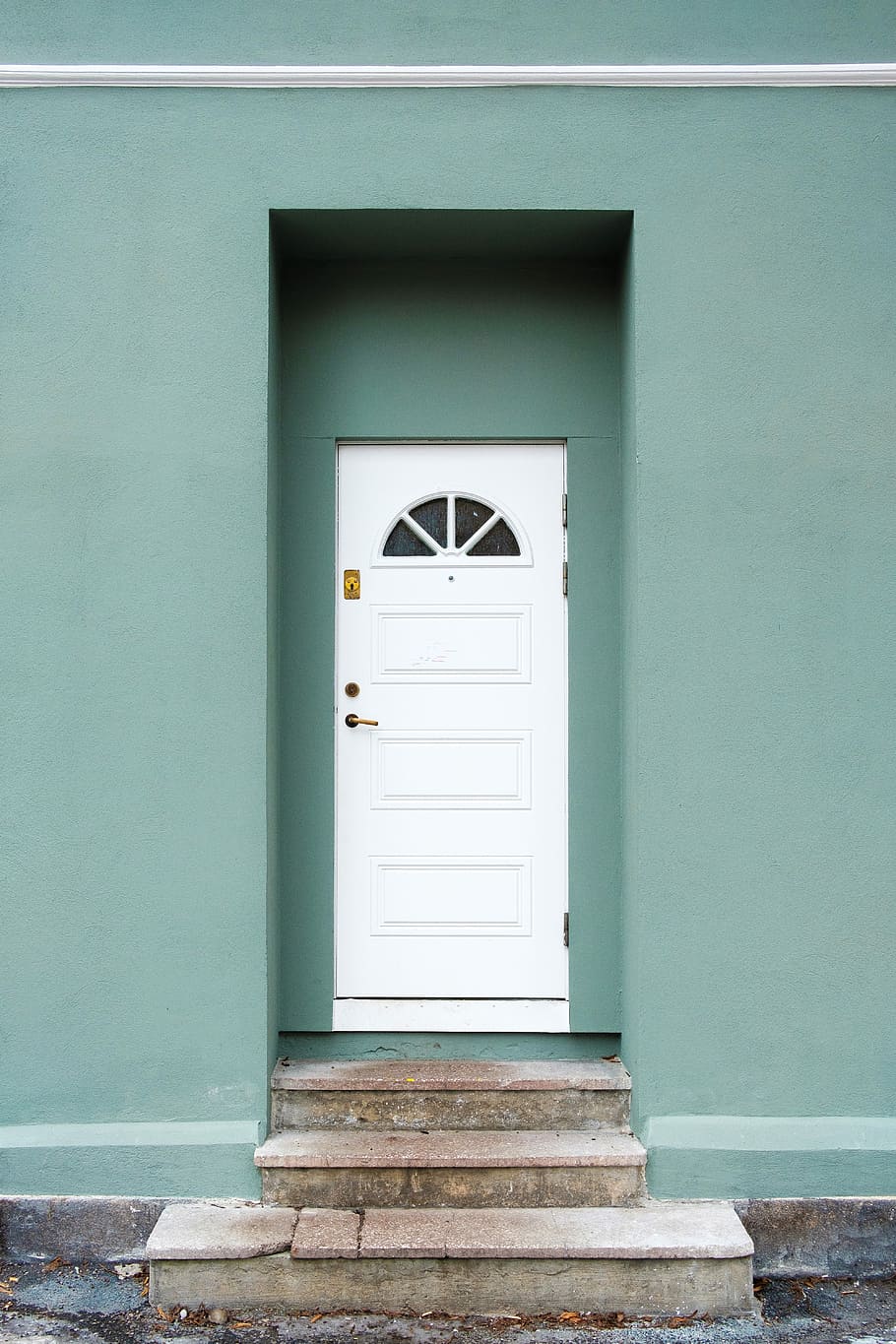 green and white concrete house during daytime photo, white wooden door